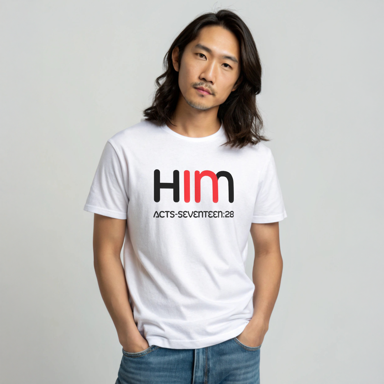 Man wearing a white t-shirt with 'IN HIM' text design on a plain background