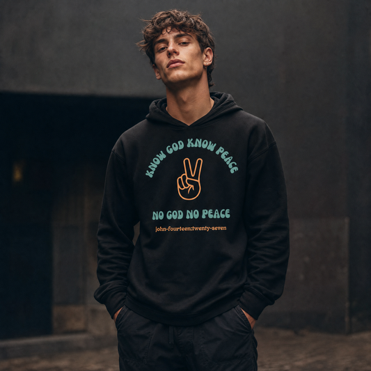 Person wearing a black hoodie t-shirt with text 'Know God Know Peace, No God No Peace' with a peace sign graphic standing against a dark background