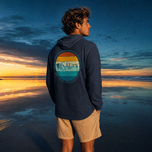 Person wearing a hoodie with a '#Salty'  on the beach at sunset