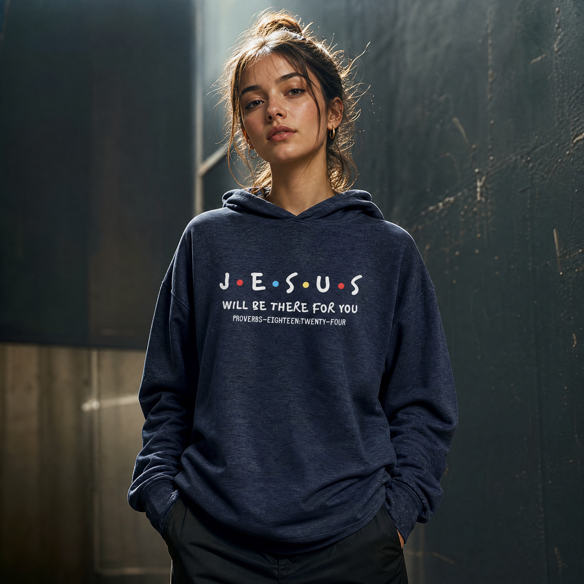 Person wearing a navy blue hoodie with text 'Jesus Will Be There For You' standing against a dark background