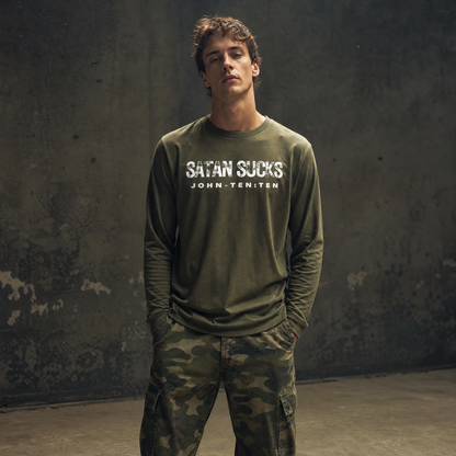 Person wearing an army green long sleeve t-shirt with text 'Satan Sucks' standing in front of a gray wall
