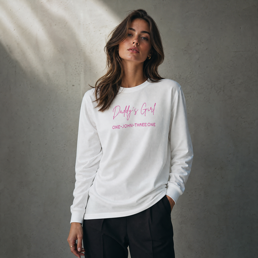 Person wearing a white long-sleeve t-shirt with text "Daddy's Girl" standing against a gray background