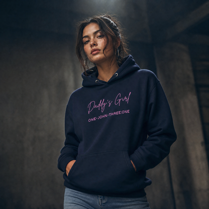 Person wearing a navy hoodie with 'Daddy's Girl' text in pink on a dark background