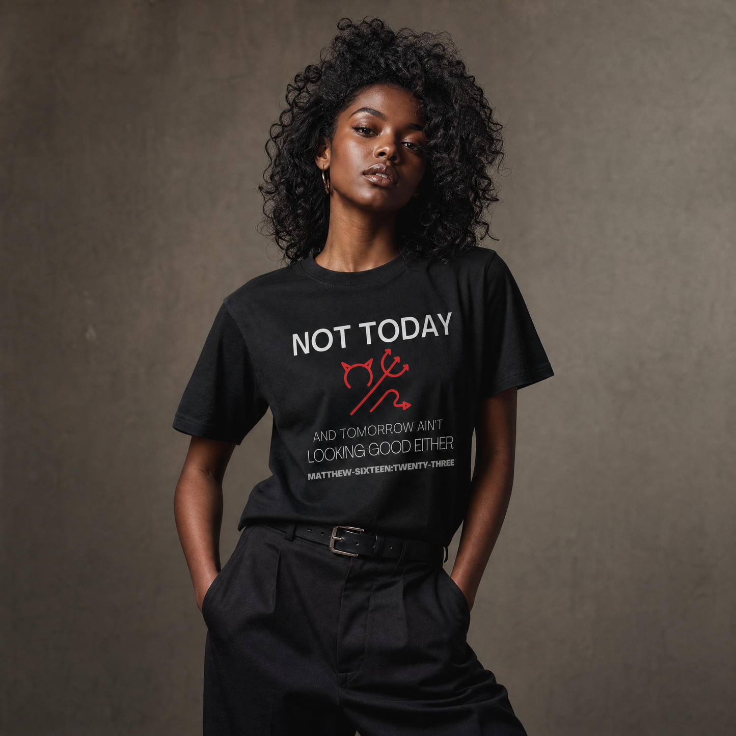 Person wearing a black t-shirt with text 'Not Today' with a symbol of a devil standing against a gray wall