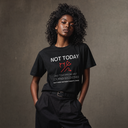 Person wearing a black t-shirt with text 'Not Today' with a symbol of a devil standing against a gray wall