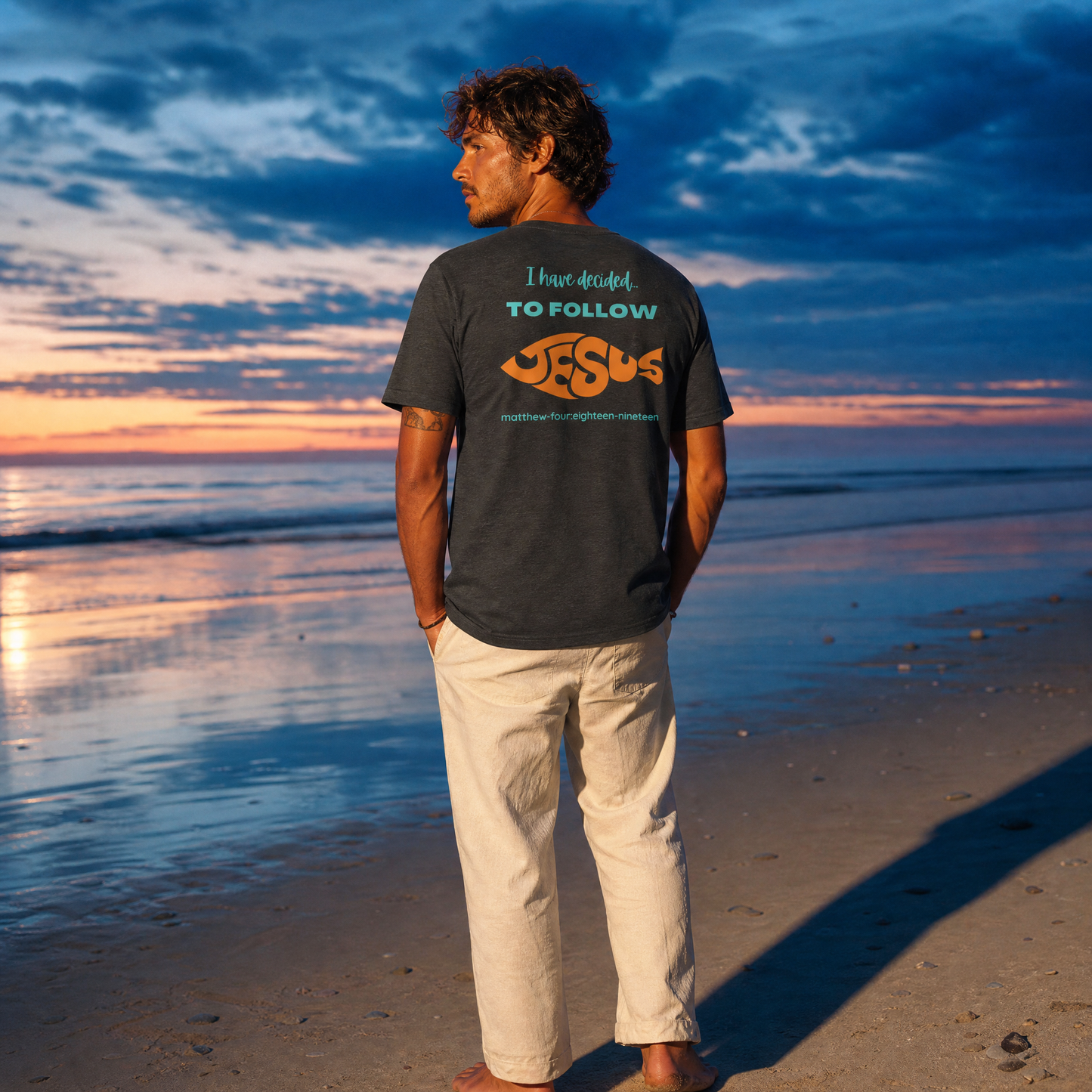 Person wearing an 'I Have Decided To Follow Jesus' t-shirt on a beach at sunset