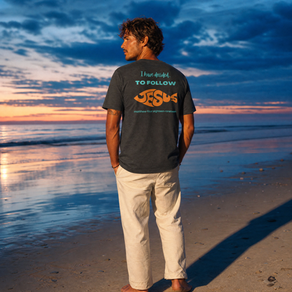 Person wearing an 'I Have Decided To Follow Jesus' t-shirt on a beach at sunset