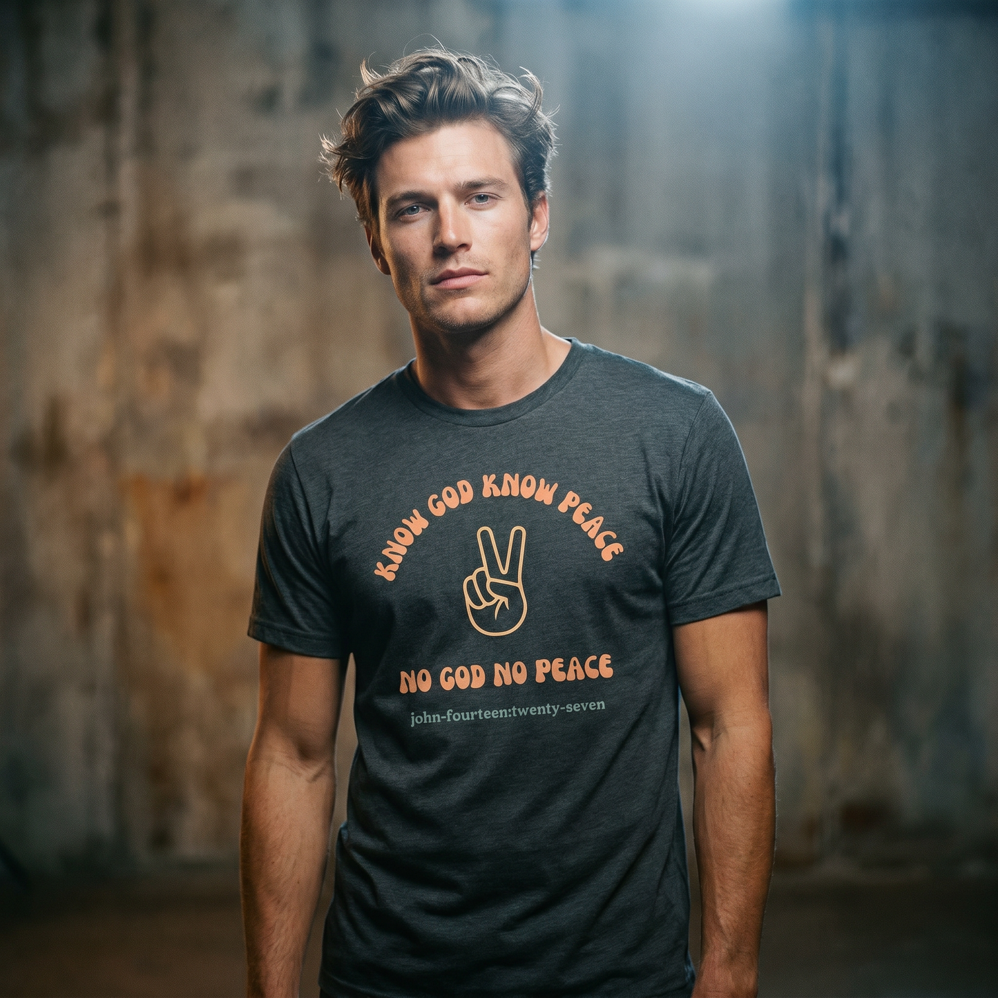Man wearing a dark gray t-shirt with text 'Know God Know Peace, No God No Peace' with a peace symbol standing against a textured wall background