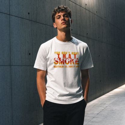 Model is wearing a white t-shirt with a graphic print on the chest that reads 'YOU DON'T WANT THAT SMOKE MATTHEW 25:41' in yellow and orange flame-style lettering, posed against a gray studio background.