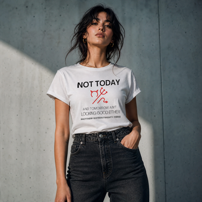 Person wearing a white t-shirt with text 'Not Today' with a symbol of a devil standing against a gray wall