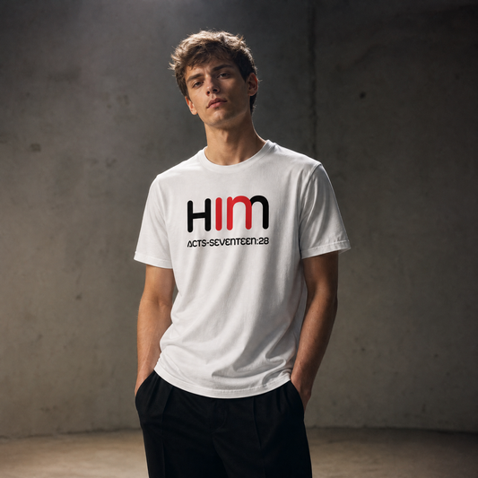 Person wearing a white t-shirt with 'IN HIM' text against a dark background
