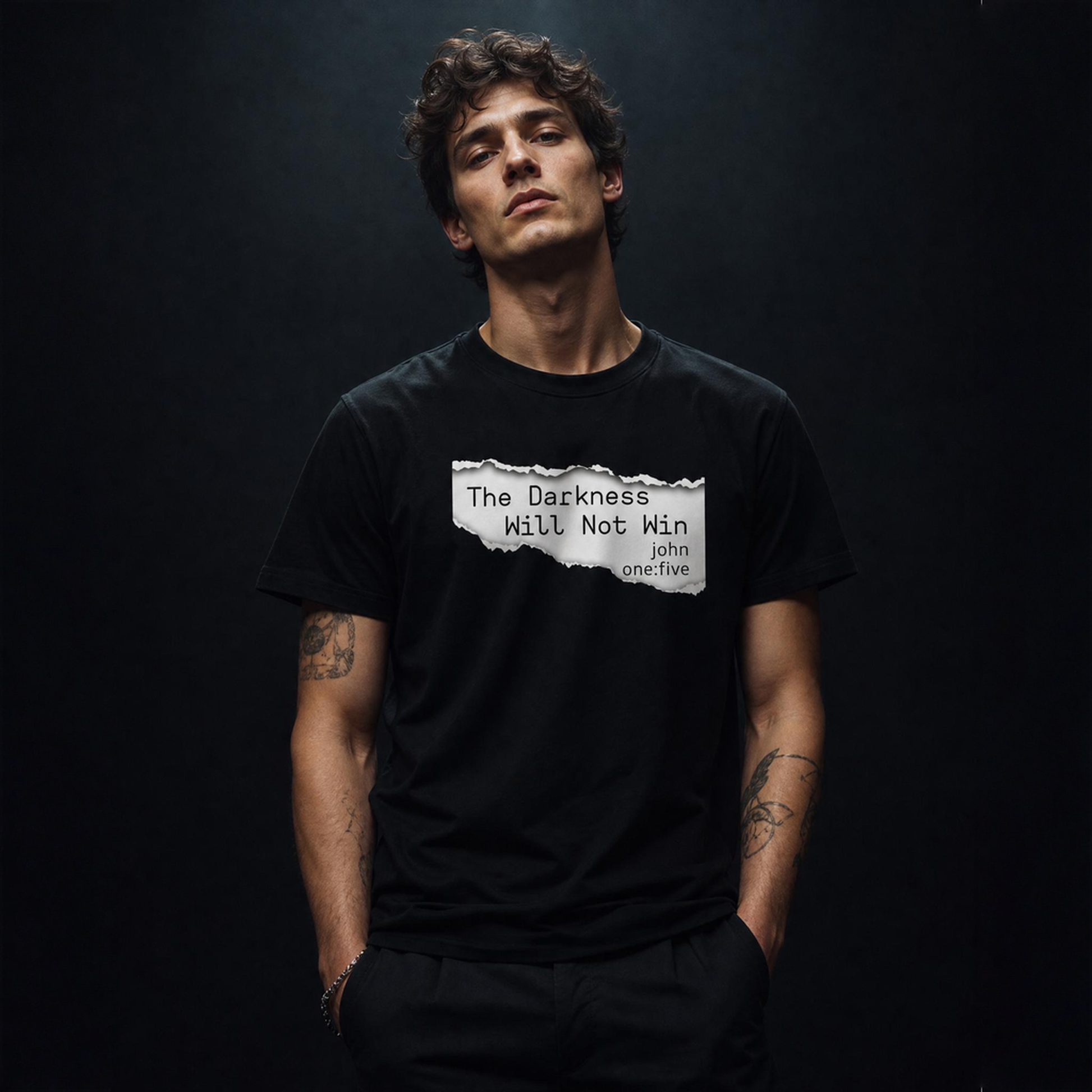 Man wearing a black t-shirt with text The Darkness Will Not Win