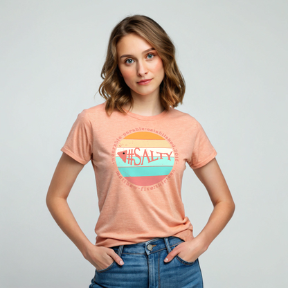 Woman wearing a peach t-shirt with '#SALTY' design on a plain background