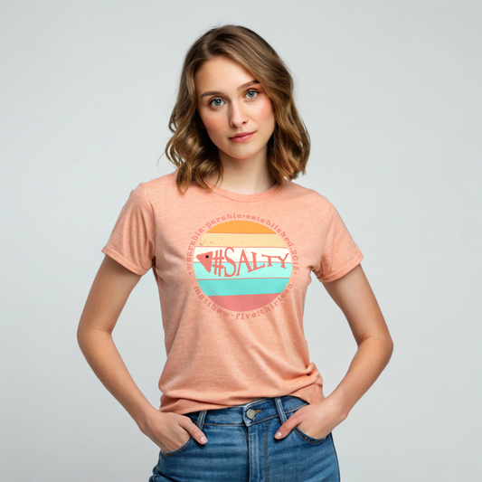 Woman wearing a peach t-shirt with '#SALTY' design on a plain background