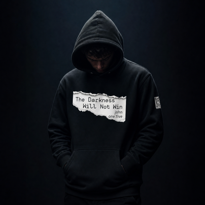 Person wearing a black hoodie with text The Darkness Will Not Win