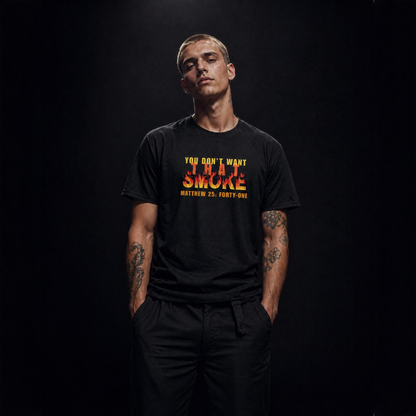 Model is wearing a black t-shirt with a graphic print on the chest that reads 'YOU DON'T WANT THAT SMOKE MATTHEW 25:41' in yellow and orange flame-style lettering, posed against a dark studio background.
