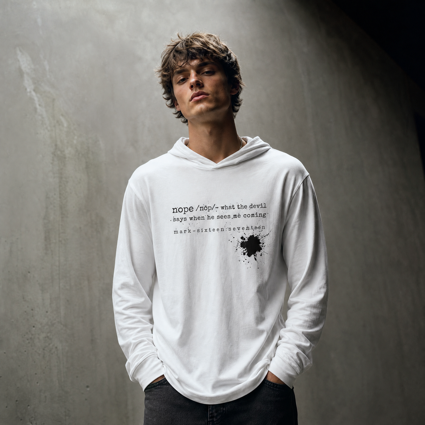 Person wearing a white hoodie with text and a against a gray background