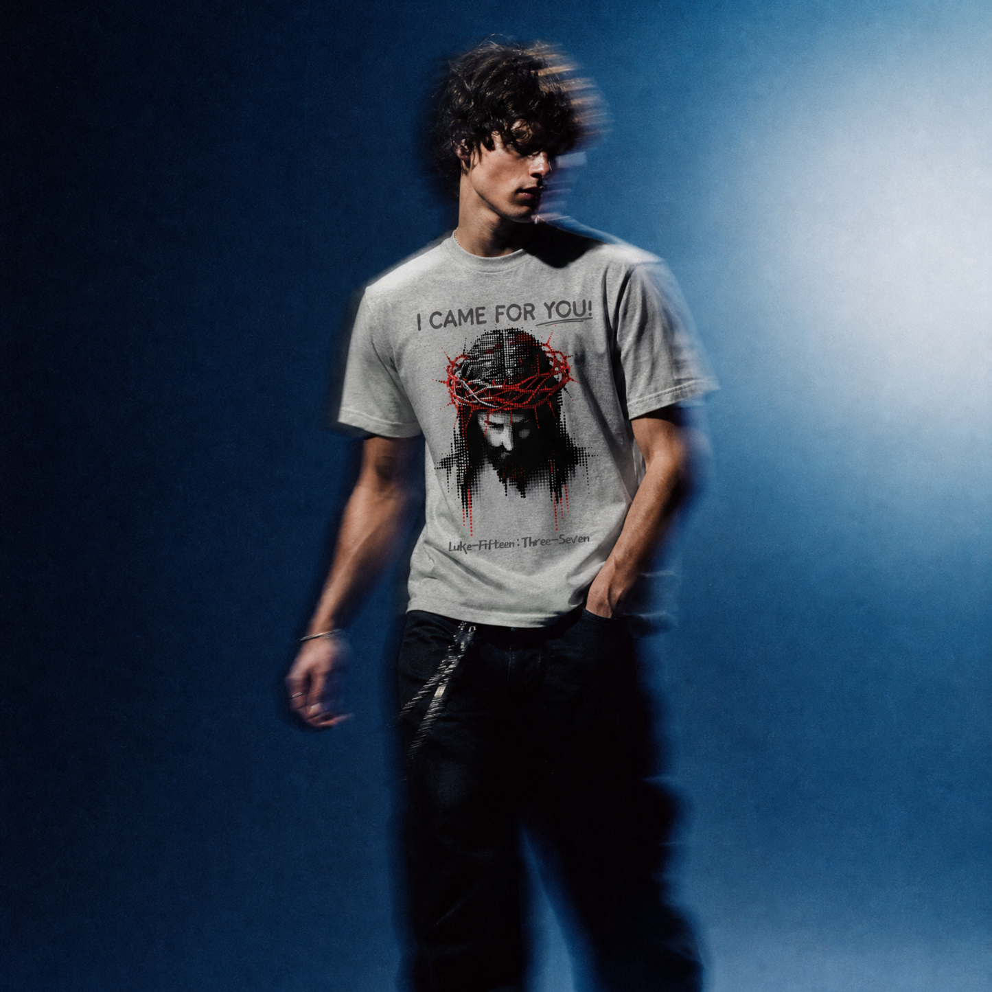 Person wearing a t-shirt with a graphic design and text against a blue gradient background