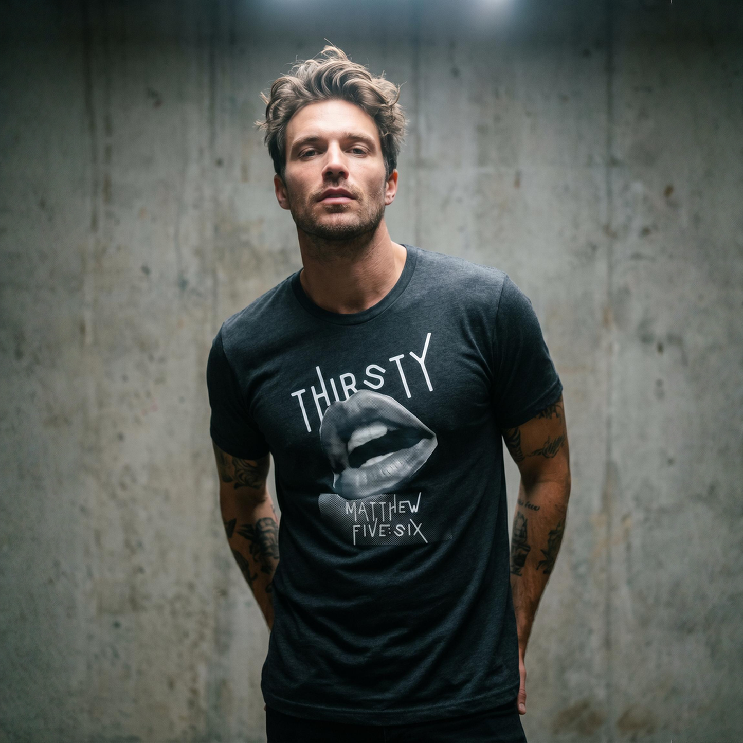 Person wearing a black t-shirt with text Thirsty and a graphic of an open mouth