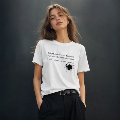 Person wearing a white t-shirt with text and a black design against a dark background