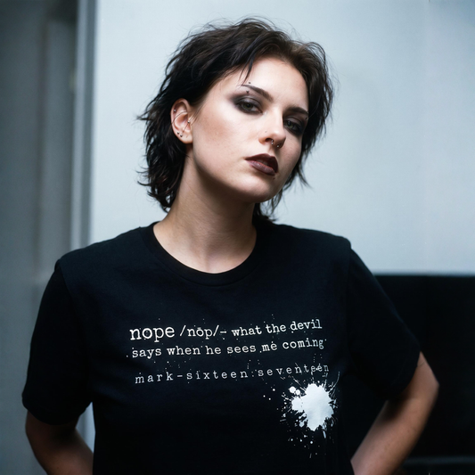 Person wearing a black t-shirt with text and a white design.